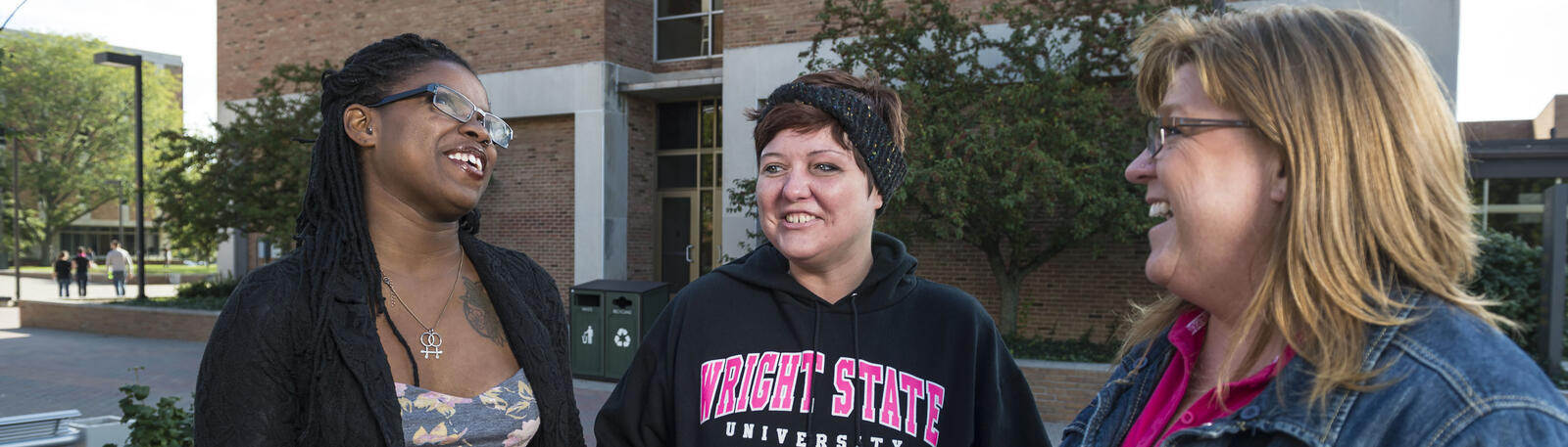photo of students standing outside on campus talking